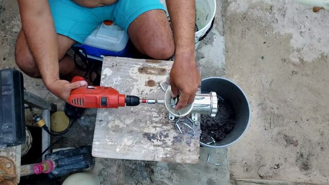 top down hands man grind bait to chum fishing artisanal work, latin cultura 