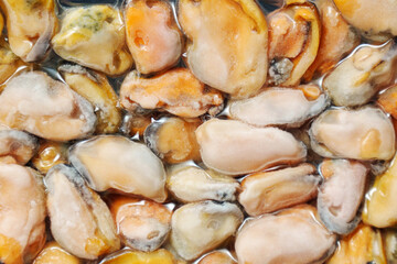 Frozen mussels background. Frozen seafood. Wholesale of fish. Peeled mussels