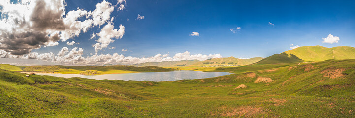 Wide angle panorama landscape with lake and mountains in Armenia