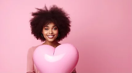 Poster African American woman with heart shape air balloon on a pink valentine background © LightoLife