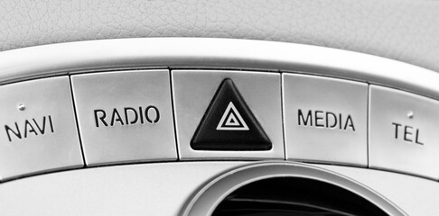 Media and navigation control buttons of a Modern car. Car interior details. White leather interior...