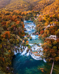 Krka, Croatia - Aerial panoramic view of the beautiful Krka Waterfalls in Krka National Park on a bright autumn morning with colorful autumn foliage and turquoise blue water