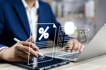 Tax and Vat concept. Government, state taxes concept. Businesman using tablet and laptop to complete Individual income tax return form online for tax payment. Data analysis, financial research.