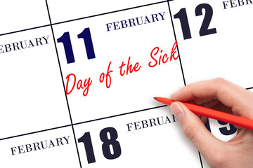 February 11. Hand writing text Day of the Sick on calendar date. Save the date.