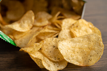Potato chips, delicious spicy for crips, thin slice deep fried snack fast food in open bag.