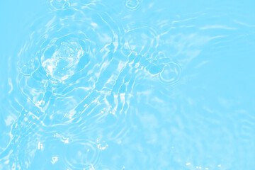 The surface of the water dripped and rippled in the basin. The transparent blue water surface is slightly shaded with unclear details