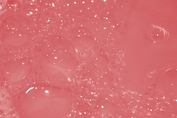 Soap bubbles wallpaper in transparent red water. defocus not clear details