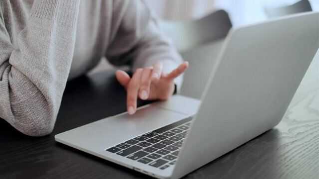 Woman's hands effortlessly glide across the keyboard of her laptop