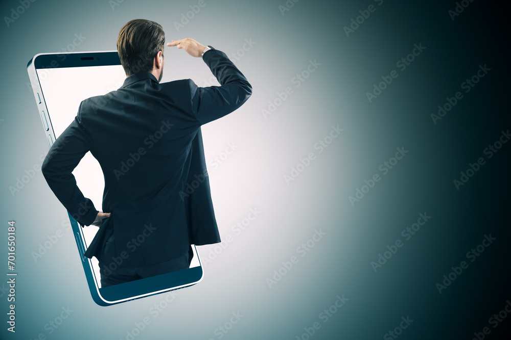 Poster back view of young european businessman inside smartphone on gray background with mock up place for 