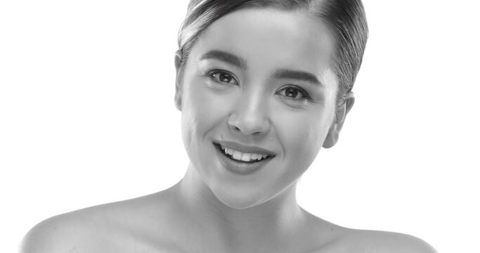 Stylish girl with hair tied up, gracefully flirting with the camera in a black and white image. She has beautiful skin and teeth. The girl is incredibly beautiful and confident. RED 8K RAW.