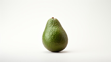 An avocado photographed alone on a plain white backdrop