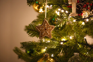 Star shaped ornament hanging on Christmas tree
