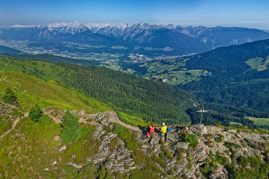 Austria, Tyrol,Aerial view of two hikers admiring view from Gamsstein mountain