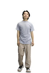 Fototapeta premium A guy in a gray T-shirt, on a white background, full-length