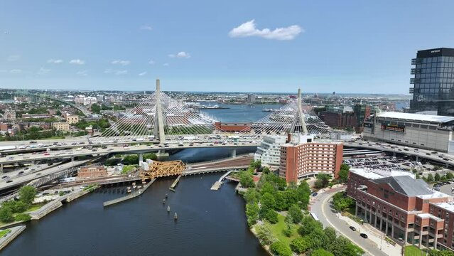 Drone shot of The Zakim bridge in Boston on a sunny day with cars driving over it.