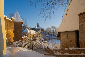 The outside of Castle Trausnitz in Landshut, Lower Bavaria with snow covered walls and roofs in winter on sunny day