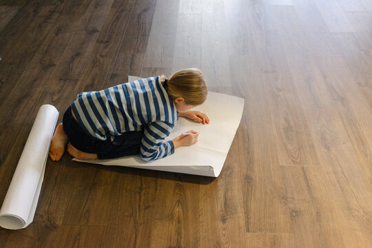 Girl drawing on paper at home