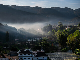 The mist shrouded the village in the valley.