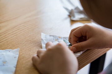 Origami - Children's hands are folding paper