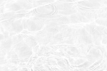 White water with ripples on the surface. Defocus blurred transparent white colored clear calm water surface texture with splashes and bubbles. Water waves with shining pattern texture background.