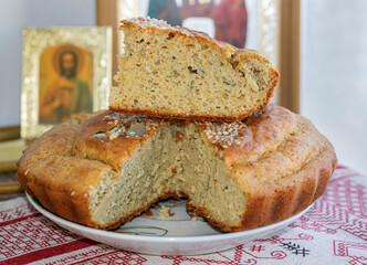 Lean homemade yeast-free bread made from corn and oat flour on rice sourdough on a towel with patterns on the background of icons and church candles