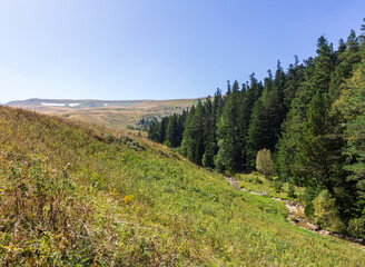 mountainous terrain and a drying stream, a sunny autumn day, walking in the bosom of nature, a panorama of the area.