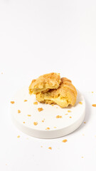 Freshly baked cream puffs or Vanilla eclairs isolated on white background