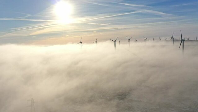 Wind turbines rise above clouds at Soutra Wind Farm in Scotland