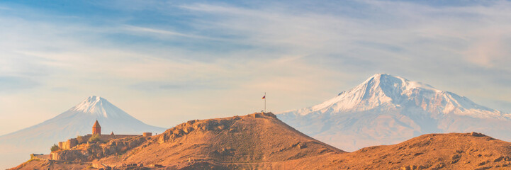 Wide angle panoramic view of sunrise with closeup of Ararat mountains with the Khor Virap monastery...