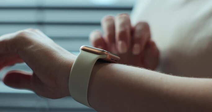 Woman browsing modern smart watches in closeup. Smart watch on female wrist. Girl making gestures on a smartwatch.