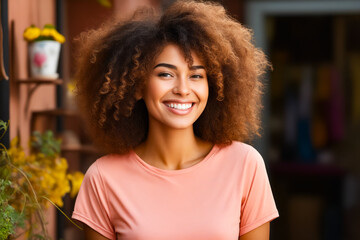 Woman with large afro smiles at the camera.