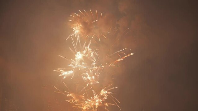 Beautiful fireworks that glow multi-colored gold in the night sky mark the end of the old year and the beginning of the new year. Happy New Year. 4k video