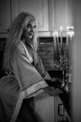 Portrait of a young beautiful blonde girl in vintage style. Black and white photo.