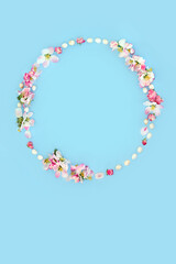 Fototapeta premium Easter egg and apple blossom flower wreath. Minimal abstract floral design with mini eggs for card, logo, gift tag or invitation on pastel blue.