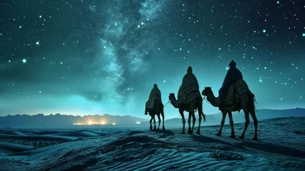 Poster the three wise men of the east on their camels riding through the desert one night following the star of Bethlehem © tetxu