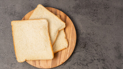 Slices of white bread on a wooden board
