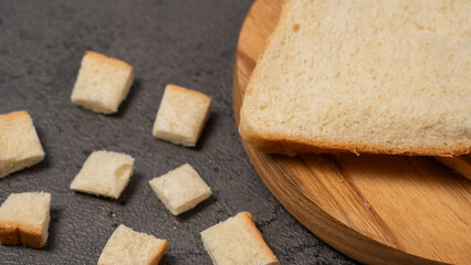 Slices of white bread on a wooden board