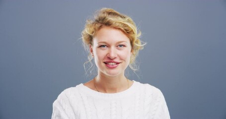 Woman, face and blowing kiss in studio for flirting, thank you or care gesture on gray background with mock up. Person, portrait and kissing emoji, expression or love for romance, gratitude and hands