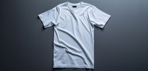 An empty white t-shirt laid flat against a modern gray background for a clean presentation.