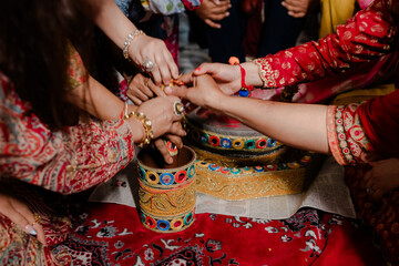 Indian man and woman, having a traditional Hindu ceremony with coconut leaves during wedding