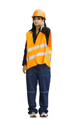A construction worker girl, on a white background, in full height, shows her finger down