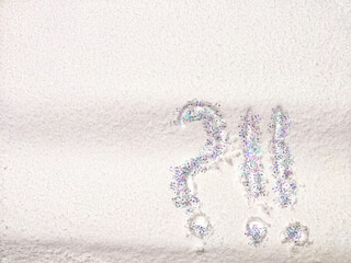 A question mark written on snow with sequins or confetti. The concept of Uncertainty of choice,...