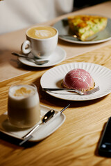 the waiter serves dishes and coffee on a tray