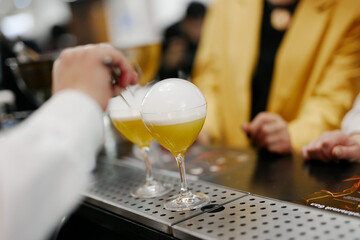 the bartender prepares an author's cocktail
