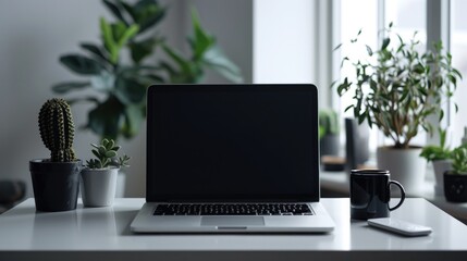 Laptop with blank screen on the table, with minimalist decoration