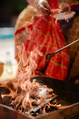 Indian man and woman, having a traditional Hindu ceremony with coconut leaves during wedding