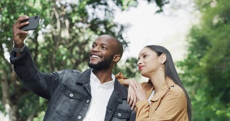 Couple, selfie outdoor and date with memory, interracial people in park for romance and photography. Love, care and happy in picture, social media post and bonding with trust, loyalty and commitme nt - Powered by Adobe