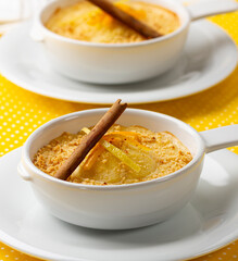 Apple crumble dessert with cinnamon on an elegant table and yellow tablecloth