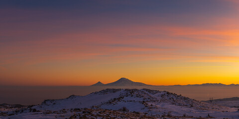 Colorful sunset over the Ararat mountains at winter as seen from the Aragats. Travel destination Armenia
