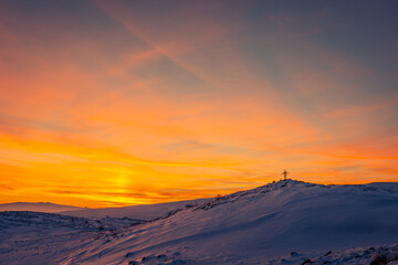 Orange sunset over the Aragats mountains at winter. Travel destination Armenia
